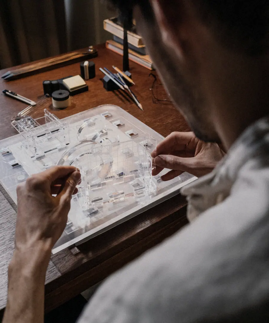Two people working over drawings at a studio table