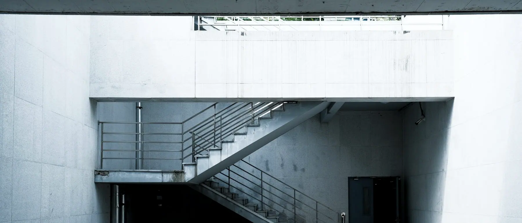 Concrete stair and landing in the service court, early morning