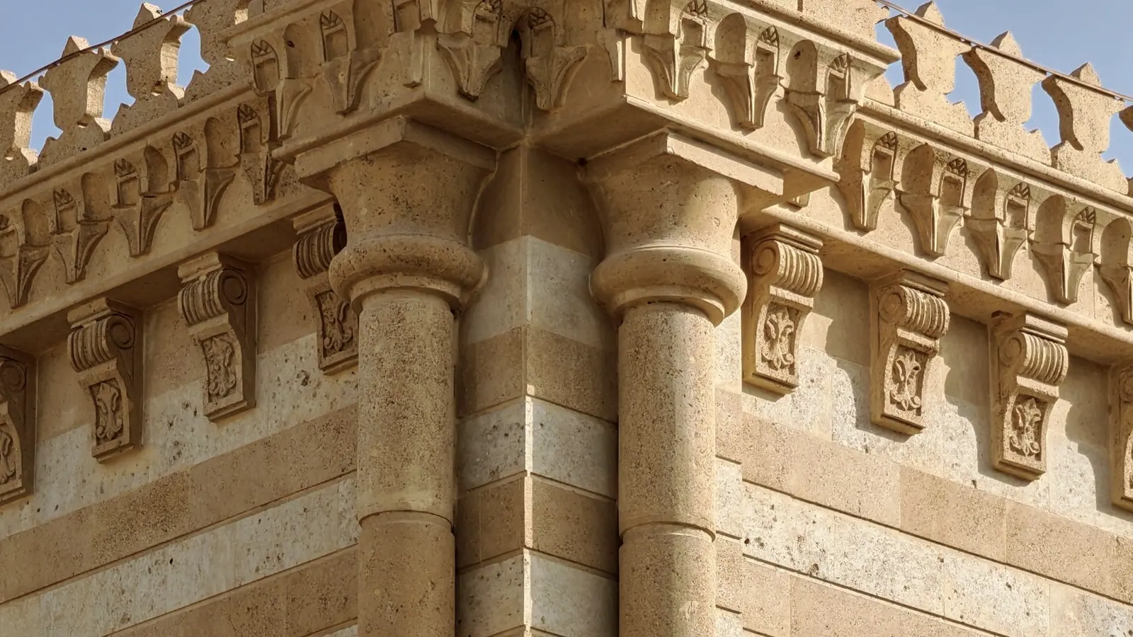 Row of dressed sandstone capitals in raking late light