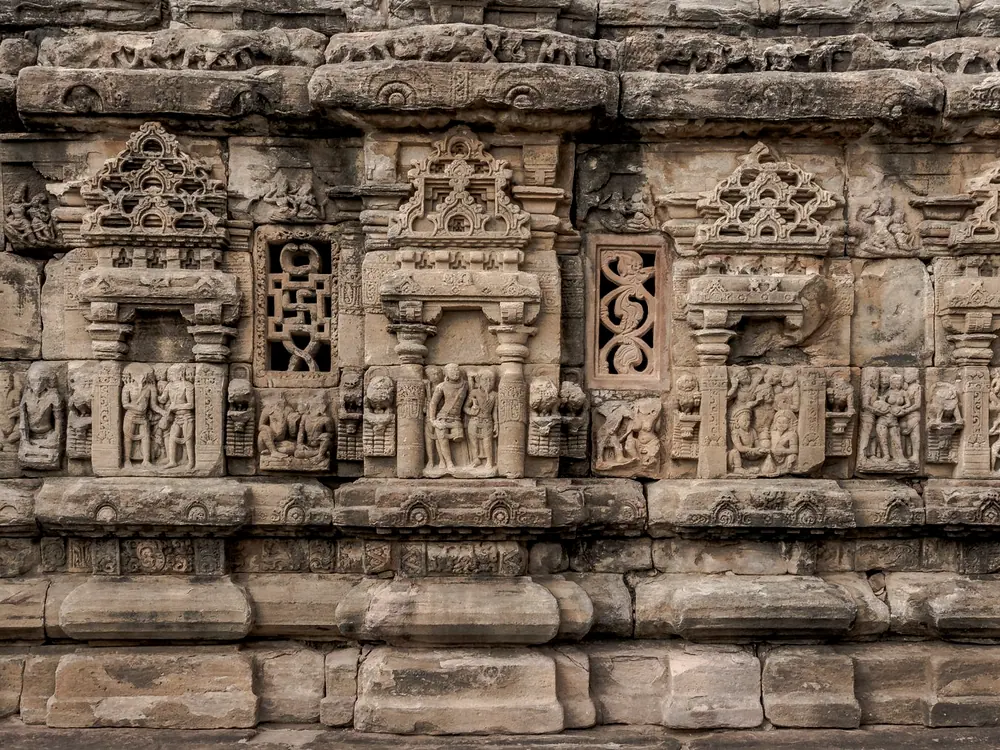 Carved stone frieze running along a wall at eye level