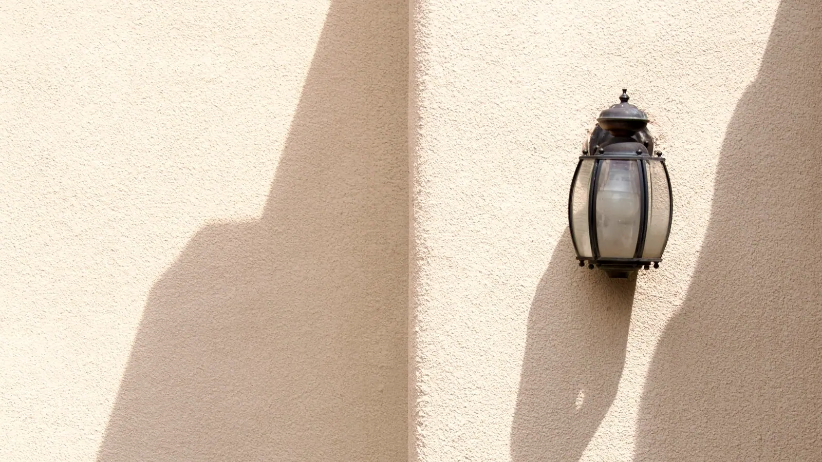 Warm plaster wall raked by late light